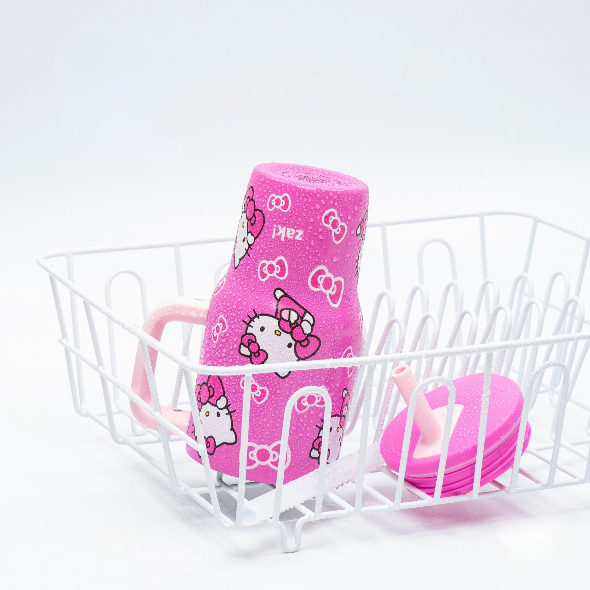 Kids pink tumbler disassembled in dishwasher rack