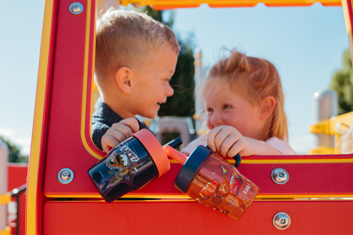 happy children at playground holding zak disney toddler cups