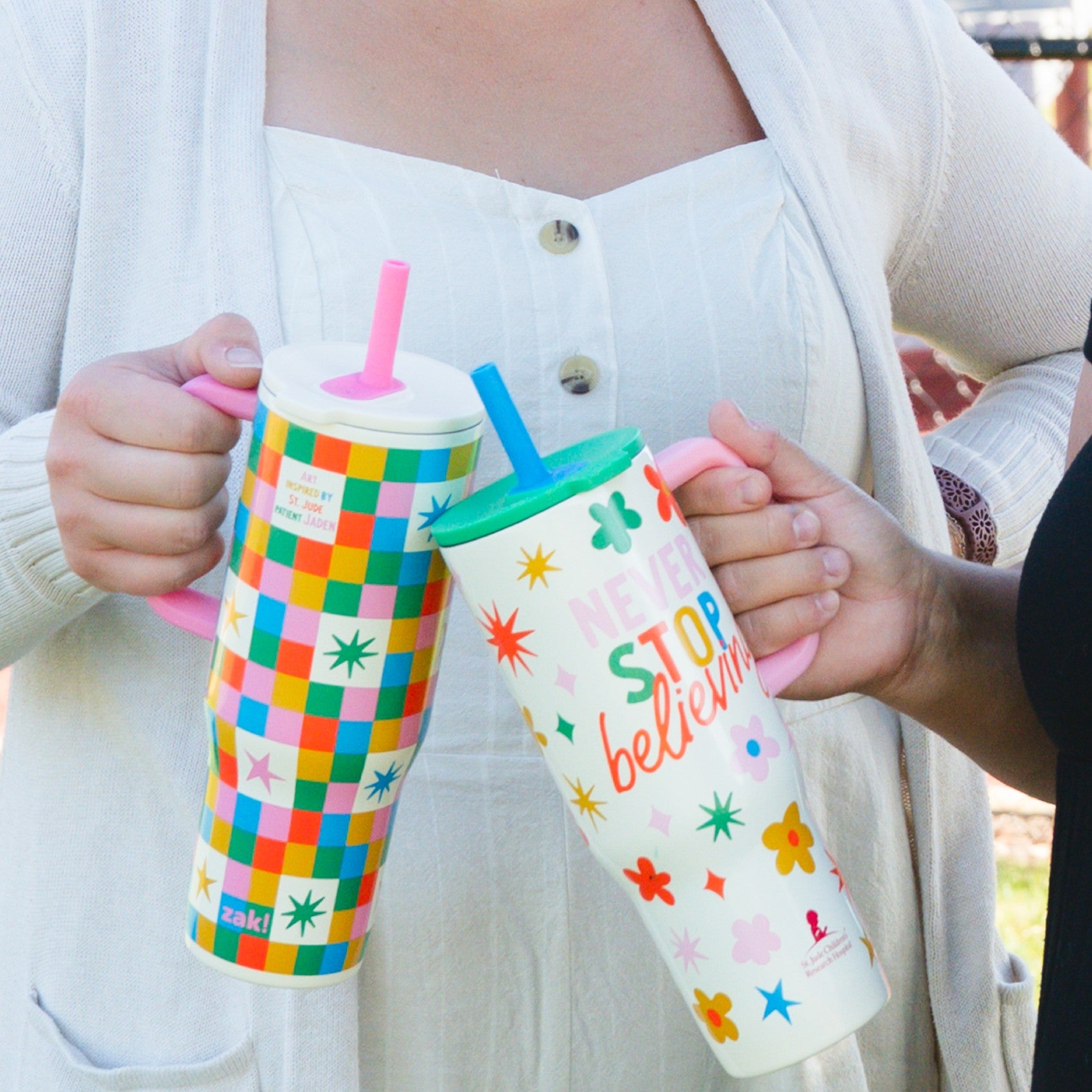 woman holding colorful zak straw tumblers