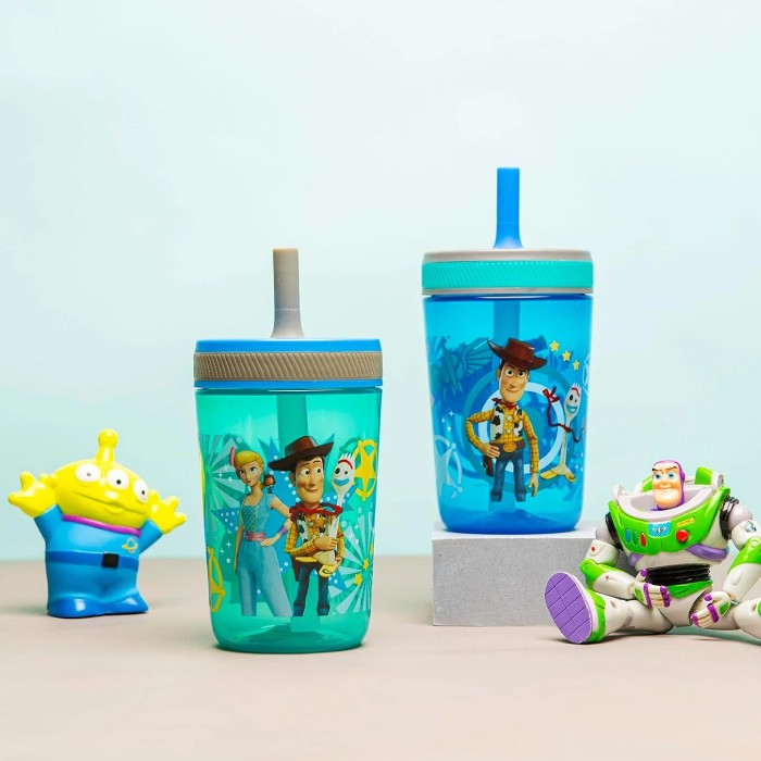 Two blue tumblers with cartoon character designs on a light blue background