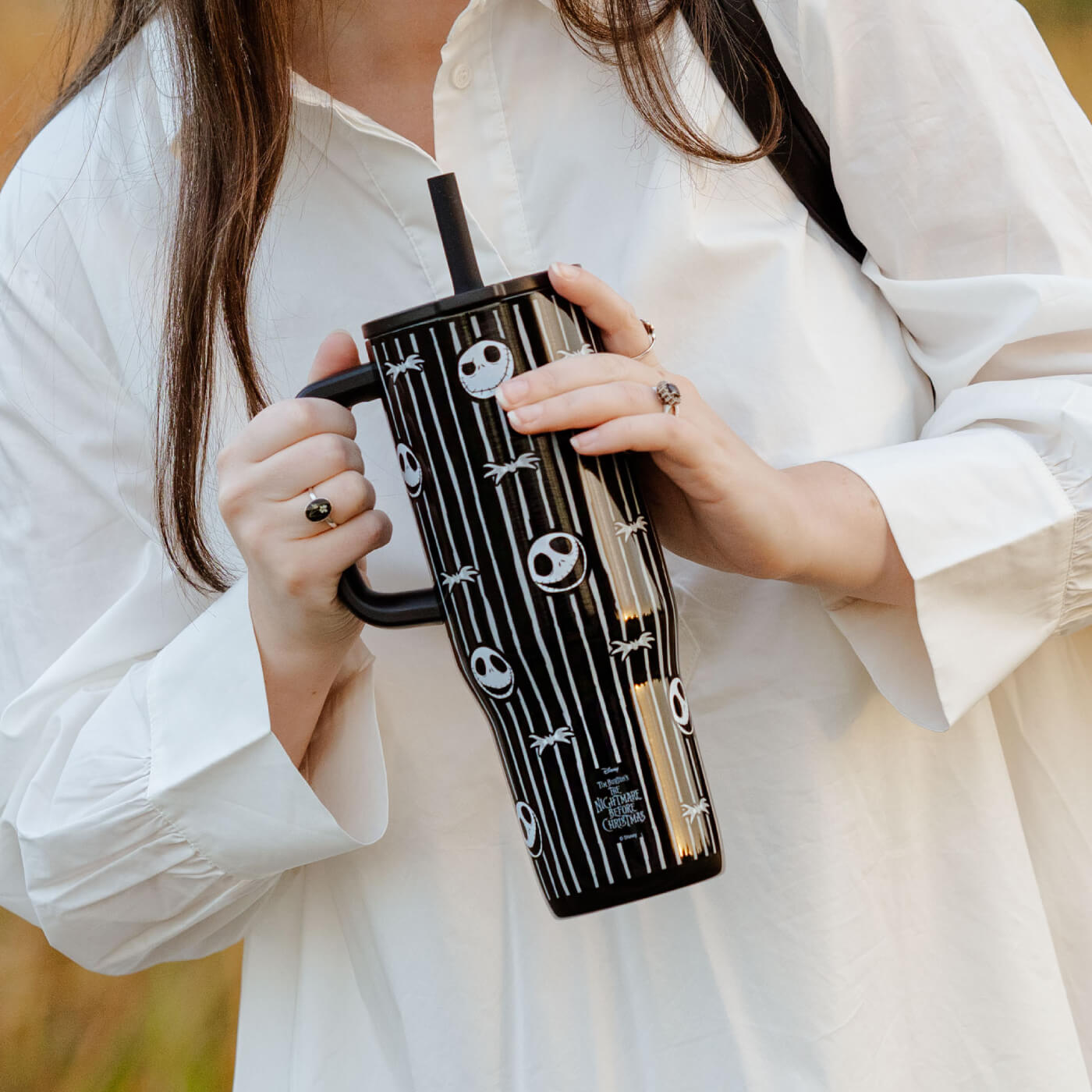 Person holding a Nightmare Before Christmas 30 ounce tumbler