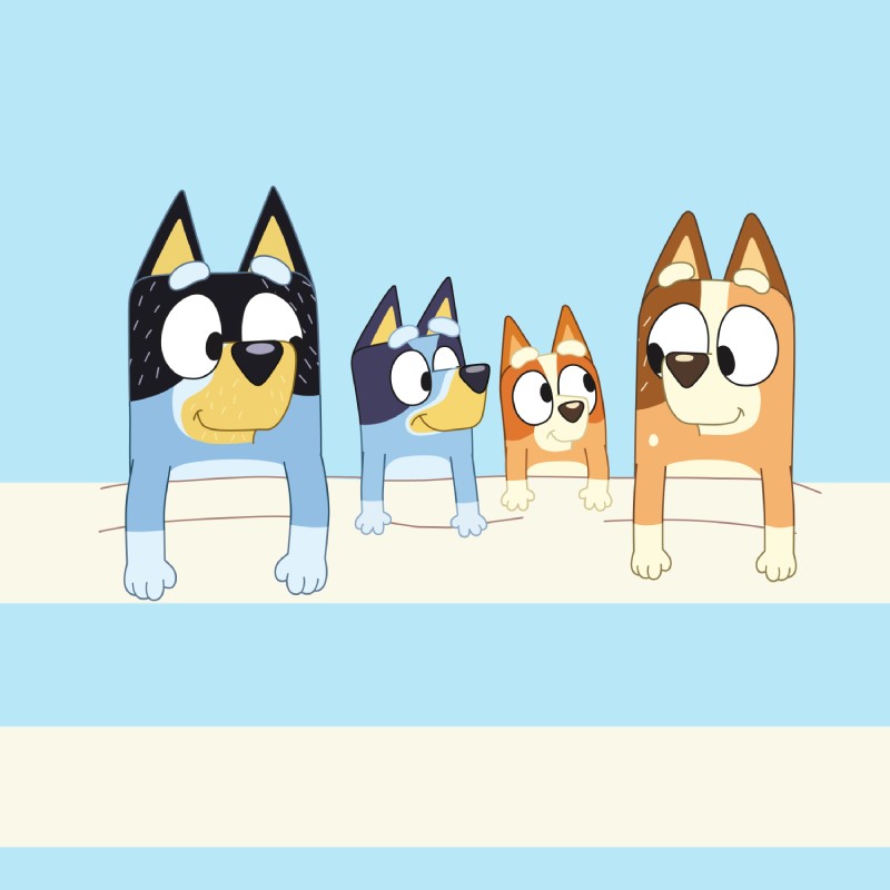 Bluey and family on a sandy beach with a blue sky background