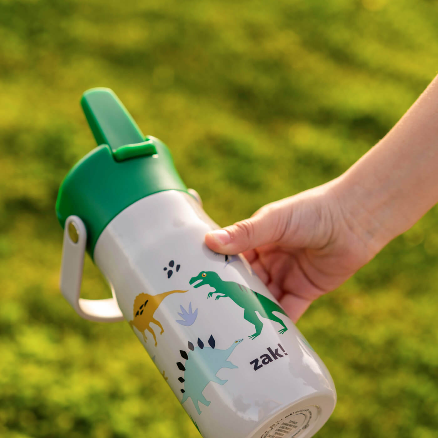 Zak Kids dinosaur water bottle with green lid and flip up spout
