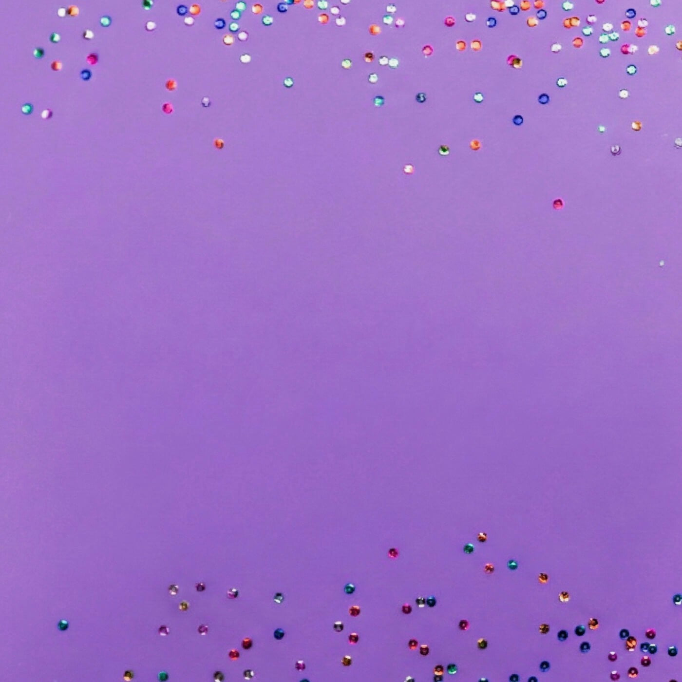 Colorful confetti falling against a purple background