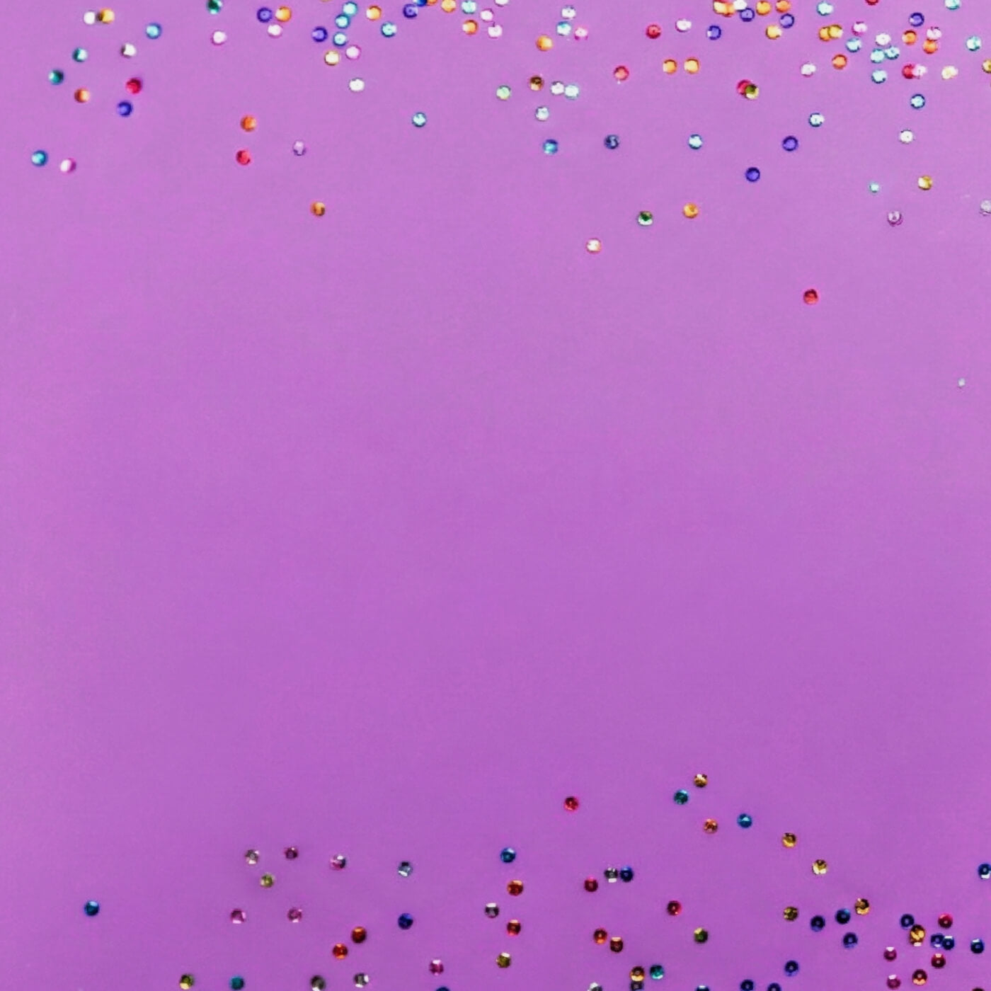 Colorful confetti scattered across a purple background