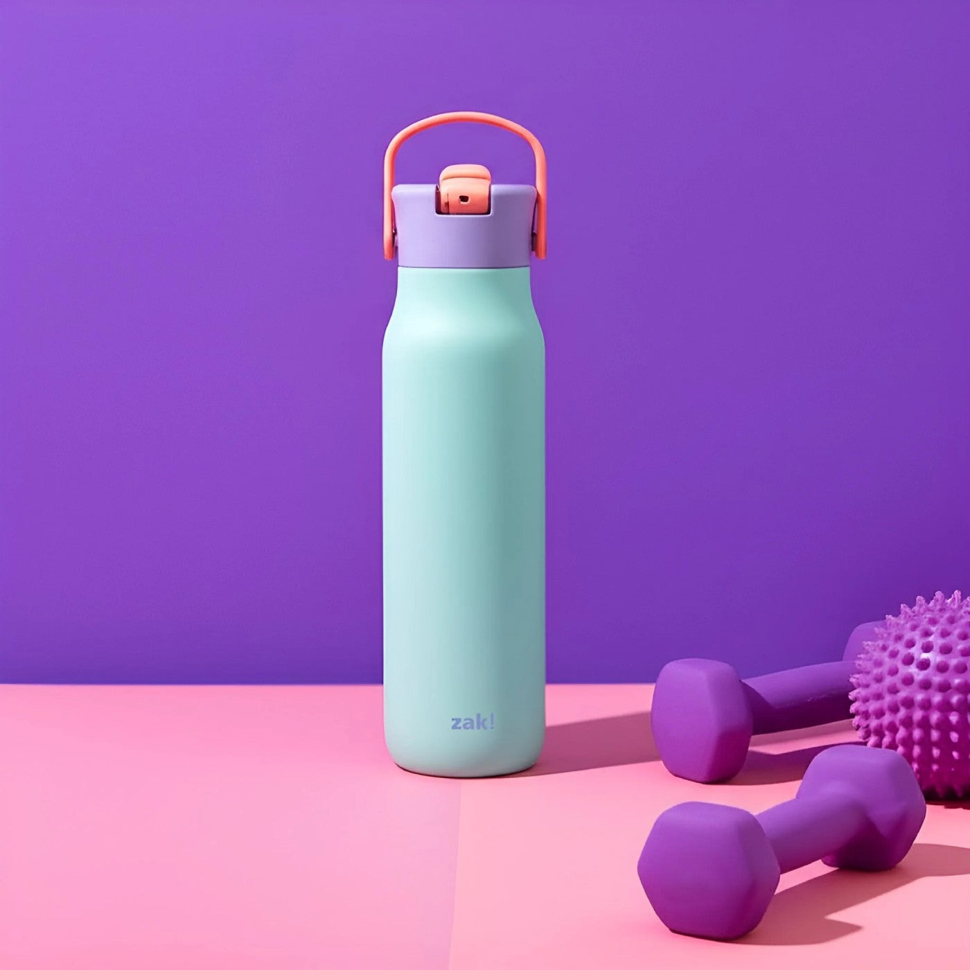 Mint green water bottle with pink accents on a pink and purple background
