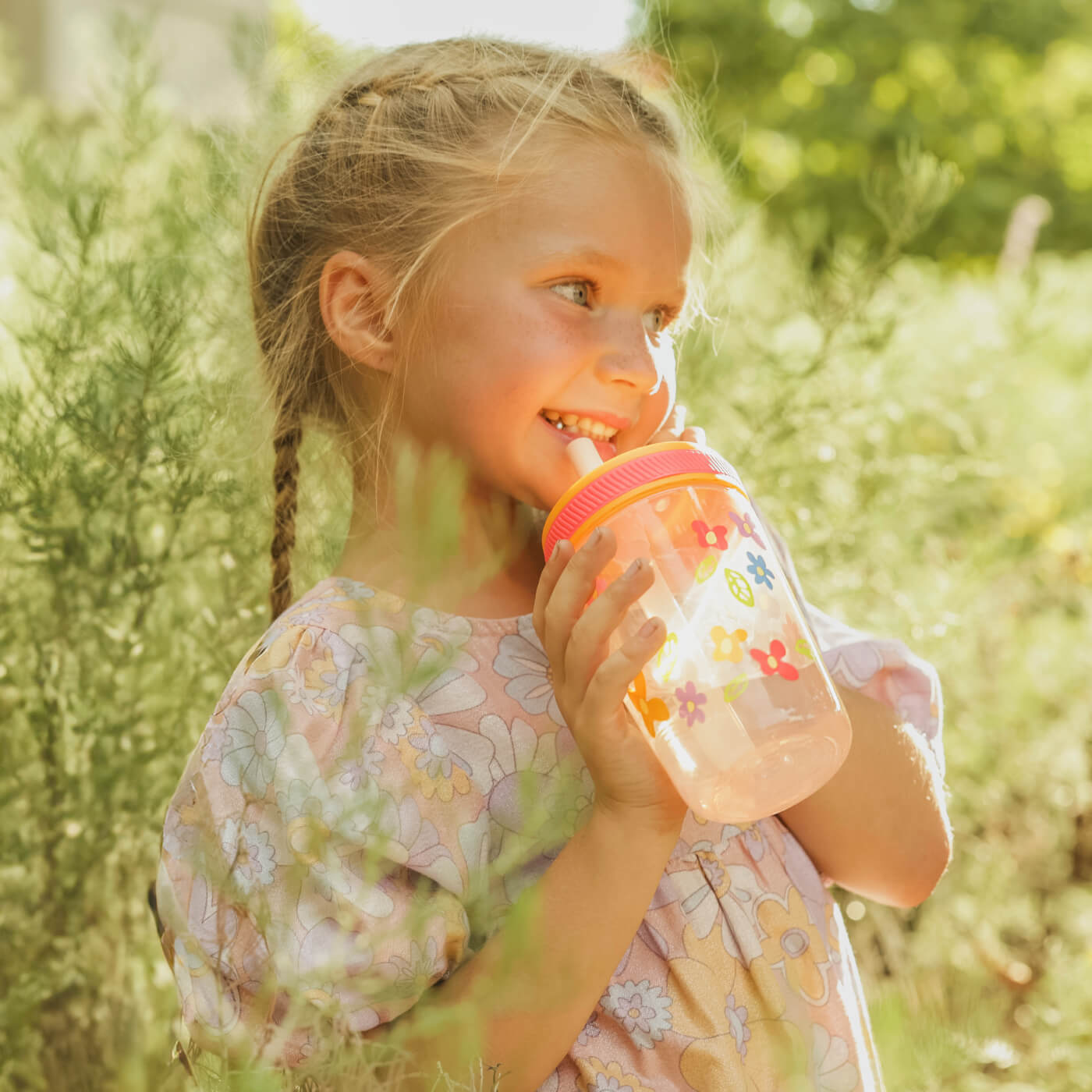 Girl drinking out of zak designs flower straw cup